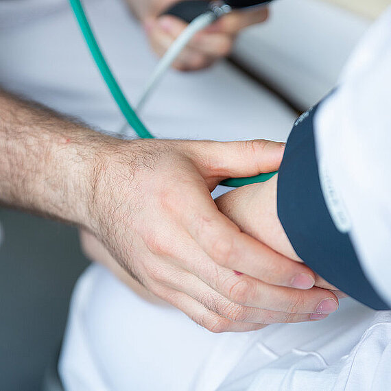 Pfleger misst den Blutdruck bei einem Patienten Pfleger misst den Blutdruck bei einem Patienten