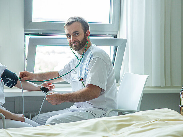 Krankenpfleger beim Blutdruck messen Krankenpfleger beim Blutdruck messen